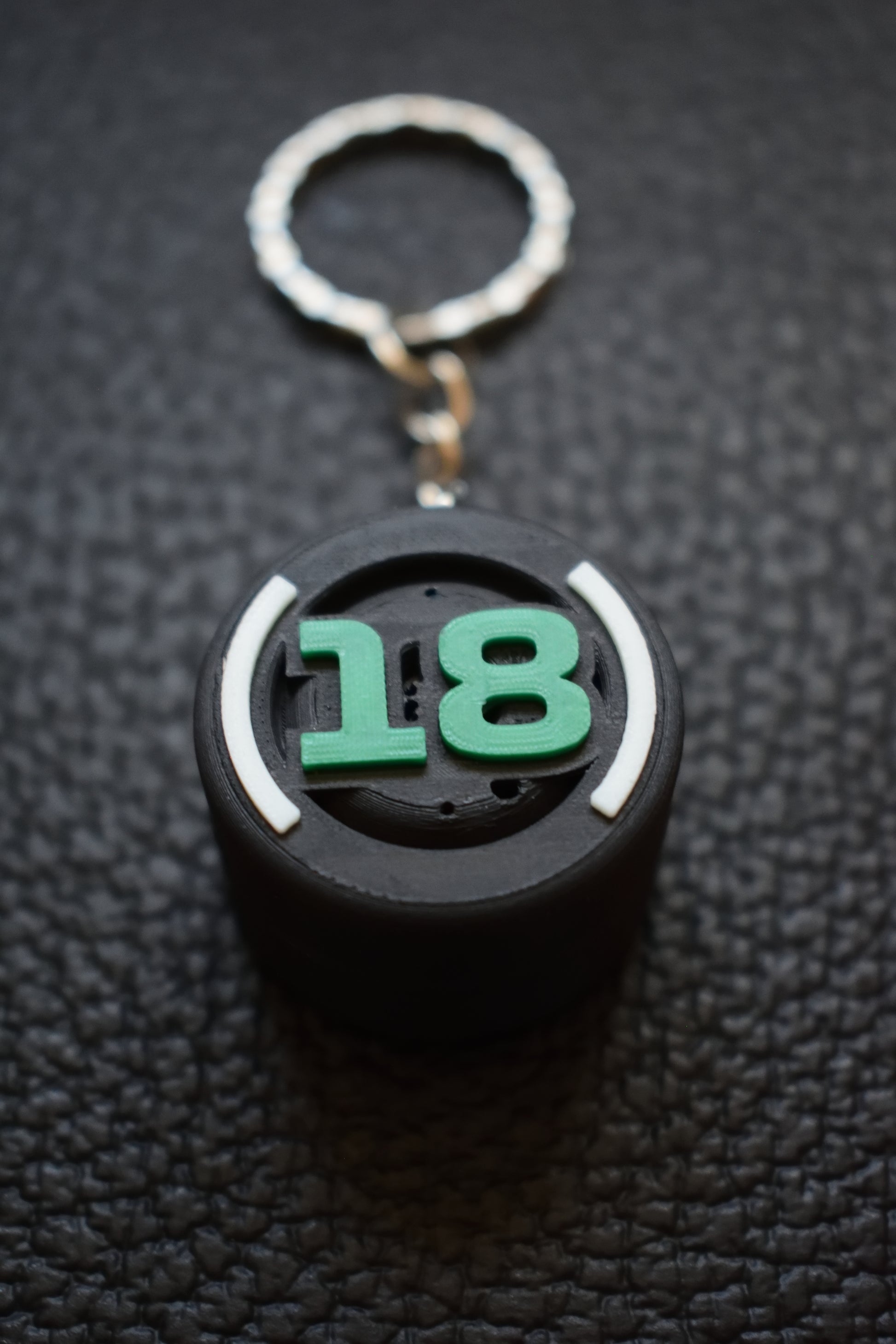 Close up view of the Lance Stroll Keychain. This formula 1 keychain is ideal for a formula 1 fan gift.